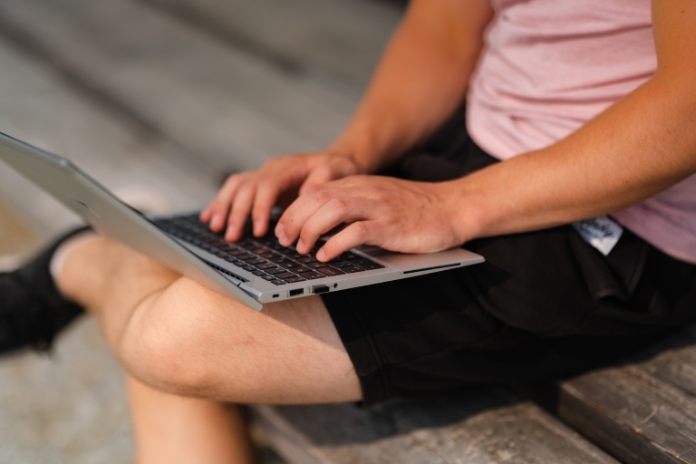 In this picture, youth, bench, laptop