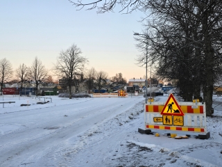 Vintervy över staden där vägen är avstängd med trafikmärken.