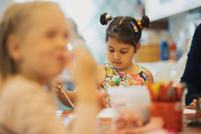 Child painting in daycare