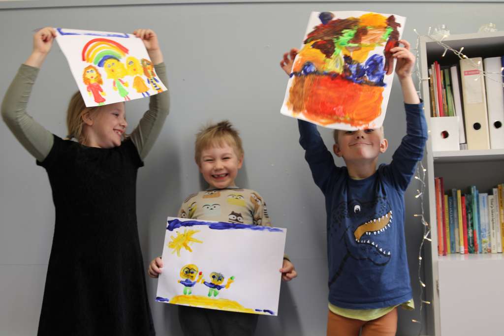 Lapset taideteostensa kanssa