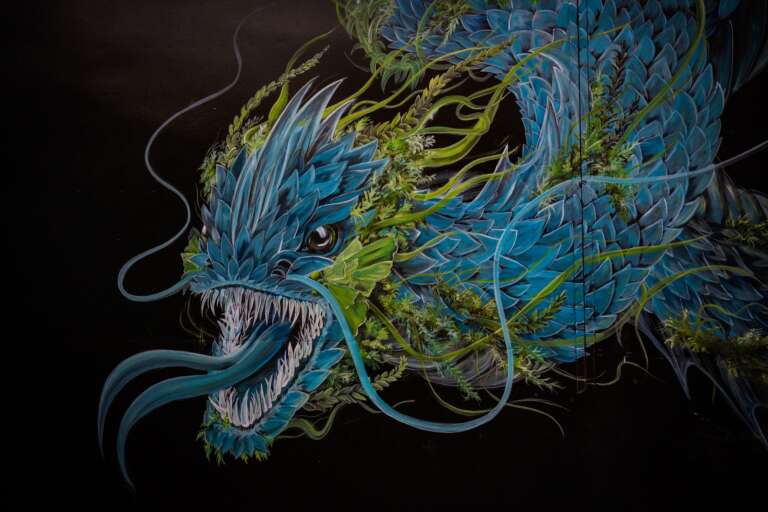 A painting of a green-blue sea monster.