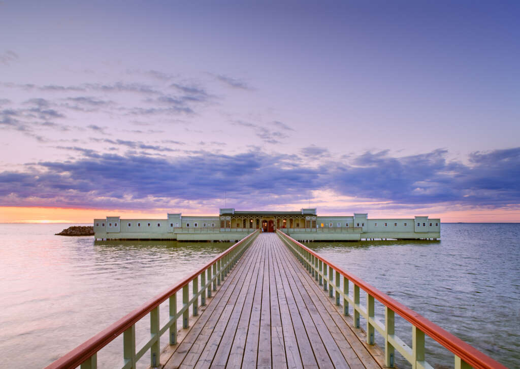 A view of Ribersborgs Kallbadhus and its jetty. Beautiful sunset in the background.