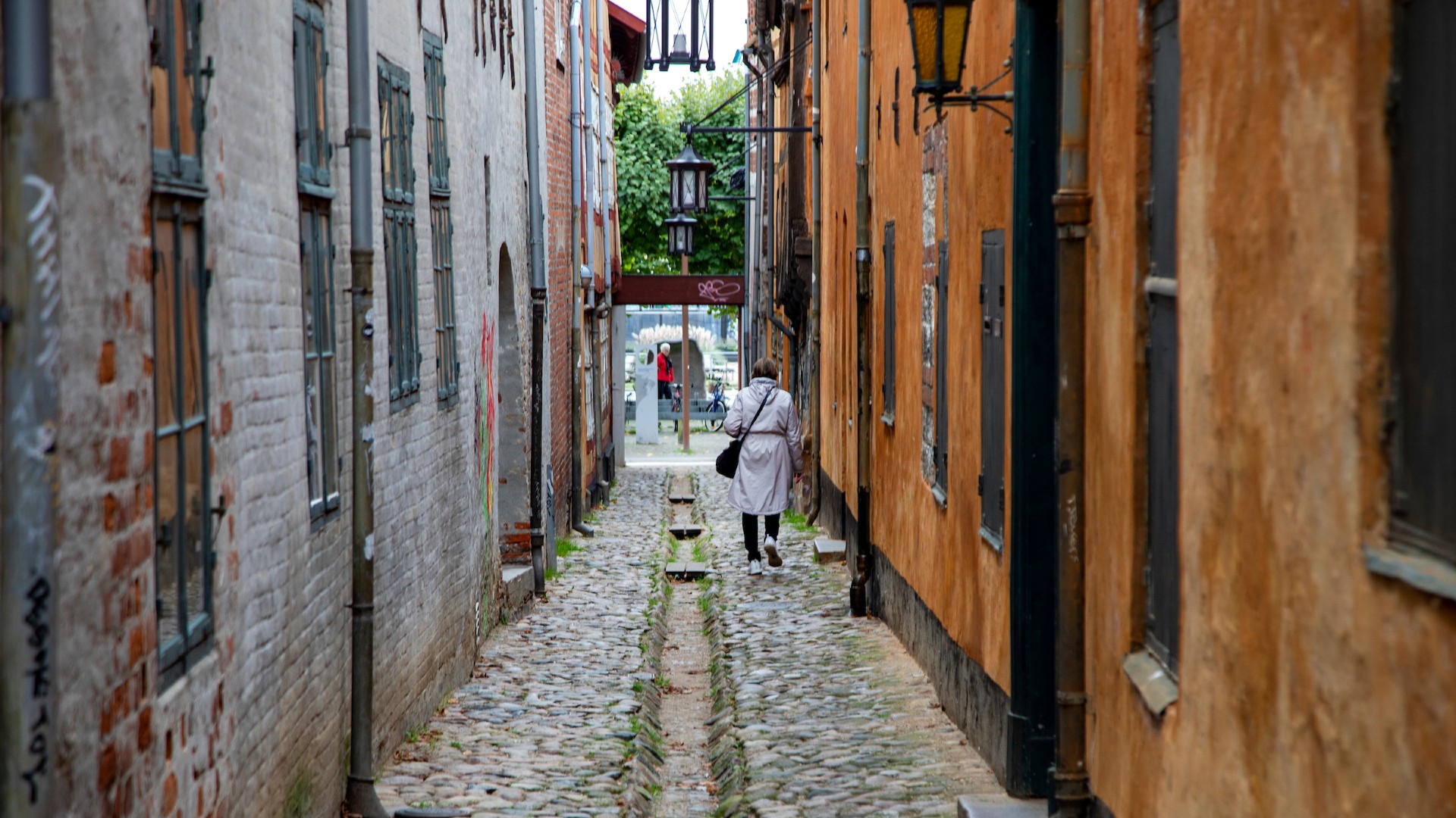 Woman walking through an alley.